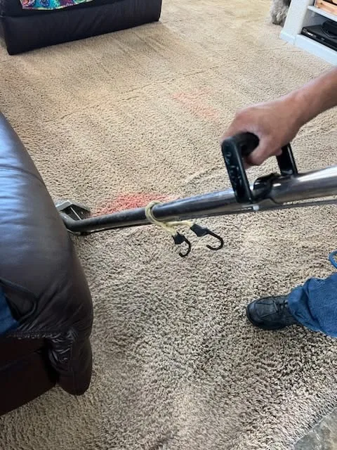 Hand tools being used on carpet during a repair
